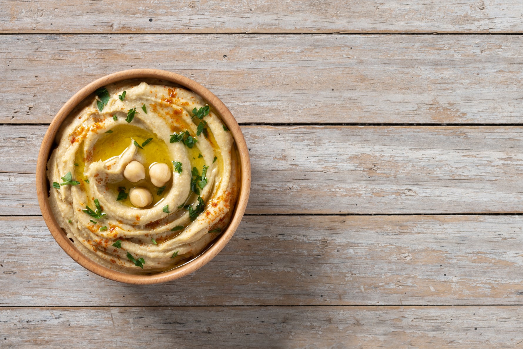 Creamy golden Greek fava split pea purée drizzled with extra virgin olive oil in a rustic bowl