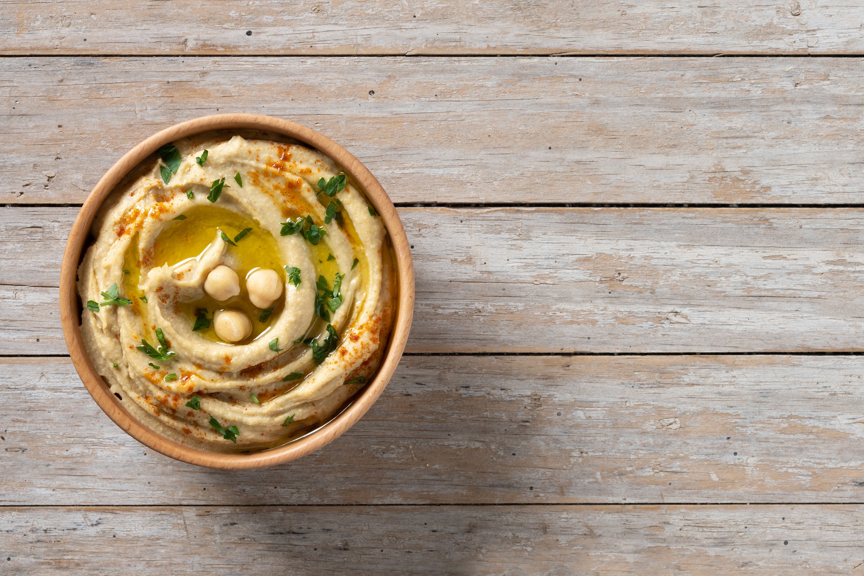 Creamy golden Greek fava split pea purée drizzled with extra virgin olive oil in a rustic bowl