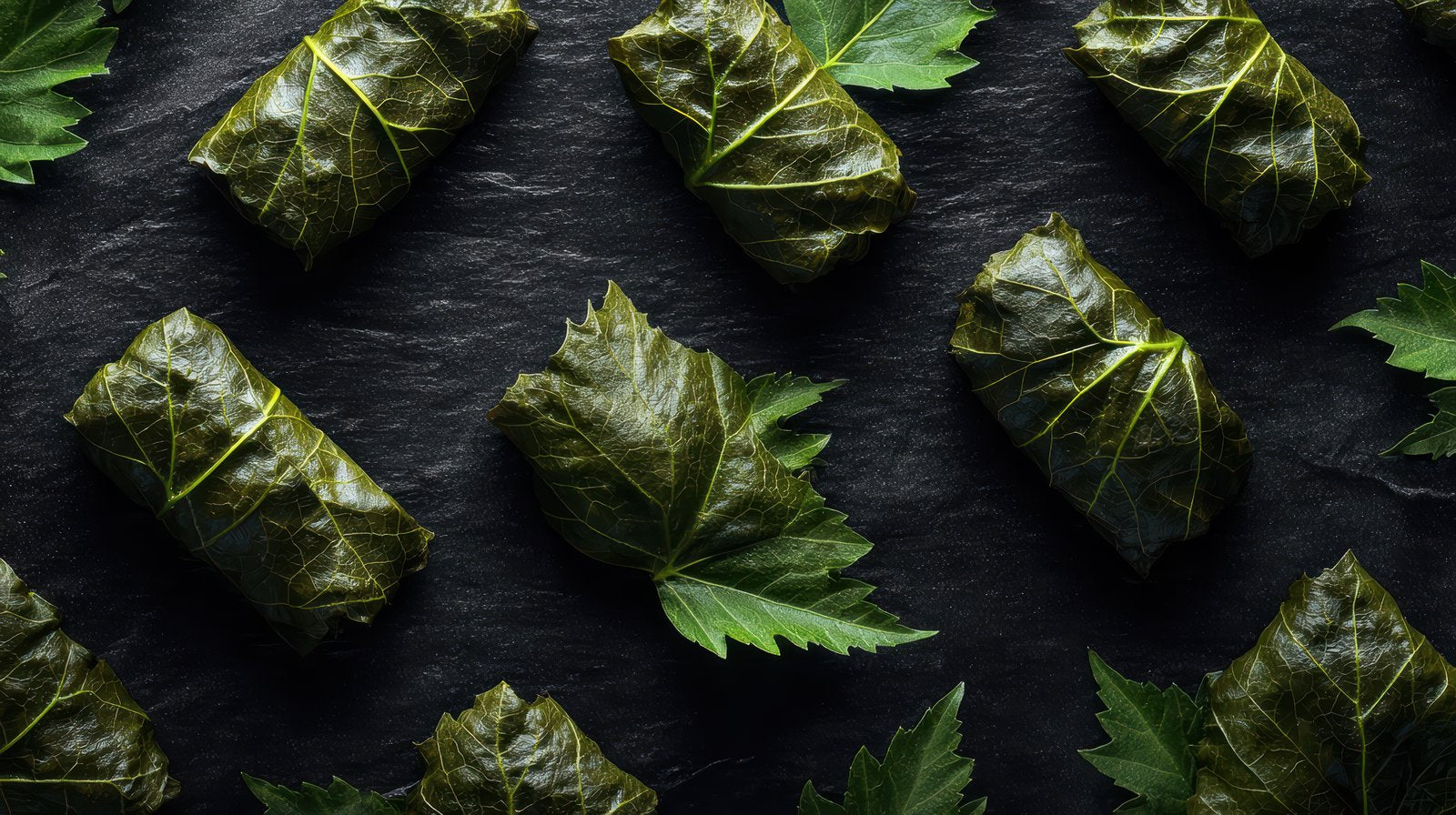 Greek dolmades stuffed vine leaves drizzled with olive oil and served with lemon