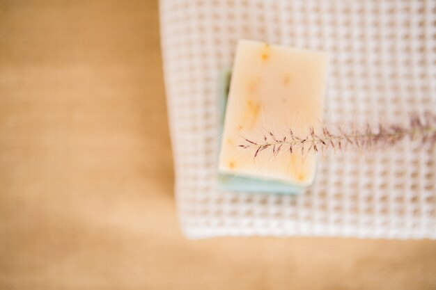 A natural olive and laurel oil soap bar resting on folded linen fabric, ready for gentle hand-washing