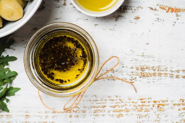 A bowl of golden green extra virgin olive oil for making Greek ladolemono sauce