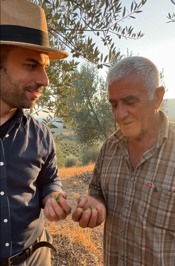 Renas, founder of Jegit, with an olive farmer in the olive grove
